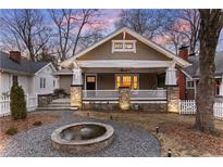 Charming home with a welcoming front porch, stone accents, and a water fountain at 536 Moreland Ne Ave, Atlanta, GA 30307