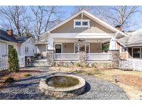 Charming craftsman-style home featuring a welcoming front porch with stone accents and a lovely front yard with a fountain at 536 Moreland Ne Ave, Atlanta, GA 30307