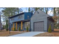 Ranch style home with gray siding, and a two-car garage at 4210 Pepperdine Dr, Decatur, GA 30034