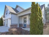 Craftsman style home with gray siding, brick accents, and a two-car garage at 2519 Barrett Preserve Ct, Marietta, GA 30064