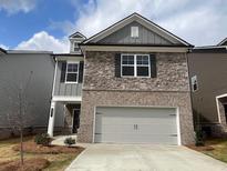 Charming two-story home with a stone and brick facade and attached two-car garage at 4341 Portsbrook Ave, Snellville, GA 30039