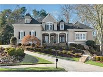 Charming two-story home with a landscaped front yard, brick driveway, and inviting entrance at 971 Saint Lyonn Cts, Marietta, GA 30068