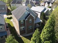 Aerial view of a two-story brick home with a dark roof and well-maintained landscaping at 2710 Royston Dr, Duluth, GA 30097