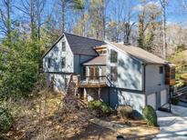 Stunning two-story home with a large deck and attached garage at 3391 Johnson Ferry Rd, Roswell, GA 30075