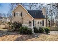 Charming two-story home with a well-manicured lawn and inviting front porch at 105 Remington Ct, Woodstock, GA 30188
