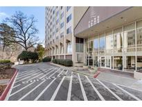 A high-rise building with well-maintained landscaping and a designated parking area at 2479 Peachtree Ne Rd # 605, Atlanta, GA 30305