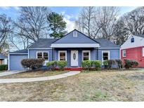 Charming blue one-story home featuring a well-manicured front yard, red porch, and inviting curb appeal at 2437 N Decatur Rd, Decatur, GA 30033