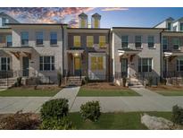 Charming townhome exterior features brick, tidy landscaping, and inviting entrance at 3239 Bartee Walk, Suwanee, GA 30024
