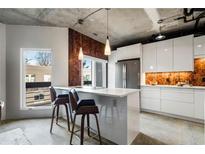 Modern kitchen features island, stainless steel appliances, and white cabinetry at 587 Virginia Ne Ave # 309, Atlanta, GA 30306