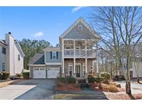 Two-story house with gray siding, stone accents, and a two-car garage at 640 Stonepark Ln, Suwanee, GA 30024