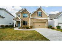 Inviting two-story brick home featuring a two-car garage and well-manicured lawn at 509 Cresentry Brk, Smyrna, GA 30082
