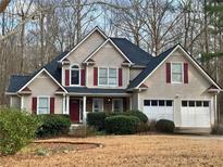 Charming two-story home featuring a two-car garage, red shutters and a well-maintained lawn at 54 Etham Pl, Douglasville, GA 30134