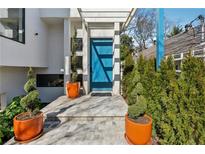 Modern home entrance with a blue door, stylish planters, and contemporary design at 727 Berkeley Nw Ave, Atlanta, GA 30318