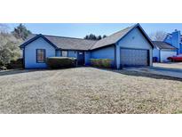 Charming single-story home with light blue siding and a two-car attached garage at 1175 Mercury Dr, Lawrenceville, GA 30045