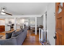 Open living area features hardwood floors, comfy sofas, and a view into the updated kitchen at 15 E Georgia Ave, Emerson, GA 30137