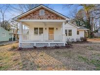Charming home with a white picket fence, covered porch, and warm wood accents at 2046 Harold Se Ave, Smyrna, GA 30080