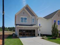 Two-story home with gray siding, brick accents, and a two-car garage at 107 Winsome Way, Woodstock, GA 30188