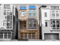 Stylish exterior elevation showcasing a modern townhome design with a garage and large windows at 607 Broadview Ter, Atlanta, GA 30324