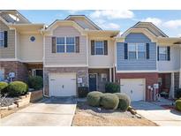 Attractive townhomes featuring attached garages and manicured landscaping for curb appeal at 55 Burns View Ct, Lawrenceville, GA 30044