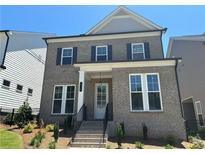 Two-story brick home with a front porch and landscaped yard at 140 Birch Tree Way, Cumming, GA 30040
