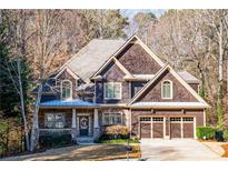 Charming two-story home with brown siding, stone accents, and a well-maintained front yard at 2240 Palmour Ct, Atlanta, GA 30337