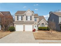 Charming two-story home featuring a well-maintained yard, two-car garage, and neutral color palette at 4035 Crabapple Lake Ct, Roswell, GA 30076