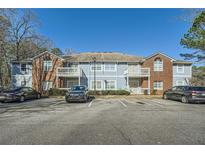 Inviting apartment building featuring brick accents and private balconies in a landscaped setting at 1342 Orchard Park Dr, Stone Mountain, GA 30083