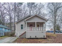 Charming single Gathering home featuring a cozy front porch and a well-maintained yard at 1137 2Nd Nw St, Atlanta, GA 30318