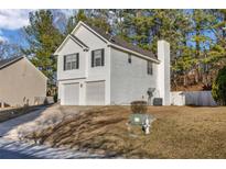Two-story house with attached garage and landscaped yard at 939 Redan Trce, Stone Mountain, GA 30088
