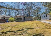 Charming single-story home with a well-maintained lawn and inviting front porch at 2103 Mcafee Rd, Decatur, GA 30032