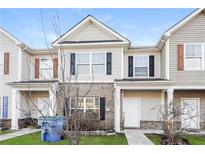 Charming townhome featuring a well-maintained lawn and a mix of vinyl siding and brick facade at 2229 Bigwood Trl, Atlanta, GA 30349