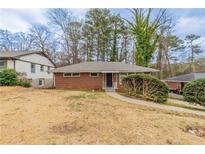 Charming one-story brick home with a well-maintained yard and mature trees at 1754 Shirley Sw St, Atlanta, GA 30310