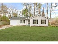 Charming single-story home with a well-maintained lawn and a one car garage at 3753 Adamsville Sw Dr, Atlanta, GA 30331