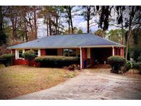 Brick ranch house with carport, mature trees, and a well-manicured lawn at 1866 Mary Lou Ln, Atlanta, GA 30316