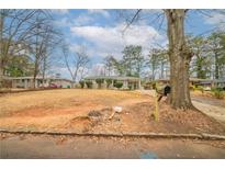 Ranch-style home with mature trees, lawn, and front driveway at 2104 Barbara Ln, Decatur, GA 30032