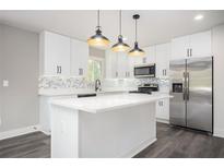 Modern kitchen features white cabinets, stainless steel appliances, and quartz countertops at 1381 Flat Rock Rd, Stockbridge, GA 30281