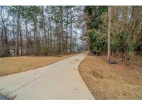 Charming single story home with a long driveway surrounded by mature trees on a large lot at 270 Merrydale Dr, Fayetteville, GA 30215