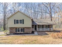 Charming split-level home featuring a brick and siding exterior and a cozy front porch at 265 N Fayette Ct, Fayetteville, GA 30214