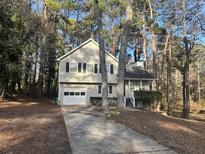 Two-story house with driveway, surrounded by trees at 8298 Blackfoot Trl, Jonesboro, GA 30236