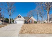 Charming single-Gathering home featuring a manicured front lawn and a two-car garage at 557 Bradford Park, Loganville, GA 30052