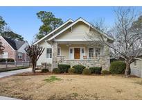 Charming bungalow with stone accents, covered porch, and manicured front lawn at 2120 Mckinley Nw Rd, Atlanta, GA 30318