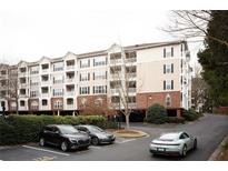 Apartment building featuring a landscaped parking area and access to garage parking below the building at 4333 Dunwoody Park # 2104, Dunwoody, GA 30338