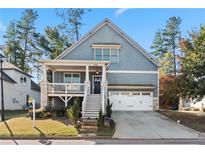 Charming two-story home featuring a welcoming front porch, attached garage, and landscaped yard at 2956 Silver Hill Se Ter, Atlanta, GA 30316