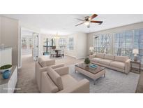 Bright living room featuring neutral tones, large windows, and contemporary furniture at 1219 Waterville Ct, Alpharetta, GA 30022