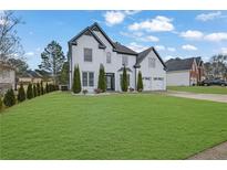 Charming two-story home with a well-manicured lawn and a two-car garage at 359 Bay Hill Ct, Lawrenceville, GA 30043