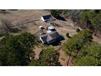 Expansive property featuring a charming home, barn, fenced yard, and ample space at 5570 Bold Springs Rd, Dacula, GA 30019