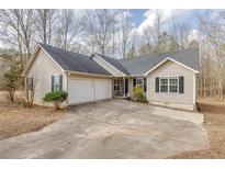 Charming single-story home featuring a two-car garage and well-maintained landscaping at 5833 Westerling Pl, Powder Springs, GA 30127