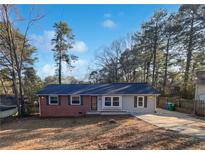 Charming single-story home with a brick facade and a well-maintained front yard at 773 Cone Rd, Forest Park, GA 30297