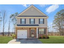 Charming two-story home with brick and siding, complemented by a well-manicured lawn and inviting curb appeal at 11997 Lovejoy Crossing Way, Hampton, GA 30228