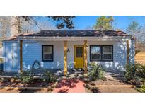 Charming single-story home featuring a bright yellow door, inviting porch, and landscaped front yard at 205 Polar Rock Sw Rd, Atlanta, GA 30315